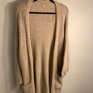 Tan cardigan, perfect for the upcoming fall weather. Length is about mid-thigh.